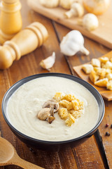 Traditional French mushroom cream soup in a bowl served for lunch, food cooking