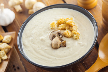 Delicious mushroom cream soup is cooking for lunch, ingredients on a table, European French food