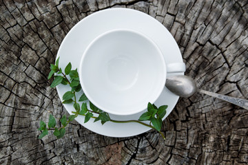 White empty cup with mint on an old wooden background, close-up,
