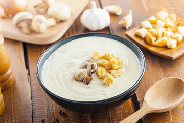 Delicious mushroom cream soup is cooking for lunch, ingredients on a table, European French food