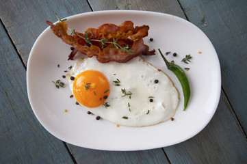 Breakfast. Fried eggs and bacon on an oval plate..