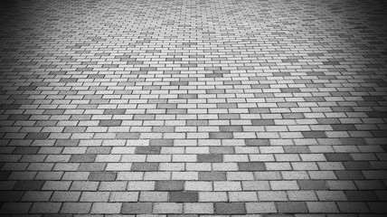 Vignette Perspective View of Monotone Gray Brick Stone Street Road. Sidewalk, Pavement Texture Background