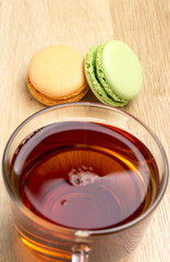 Set colorful macaroons and glass cup of black tea