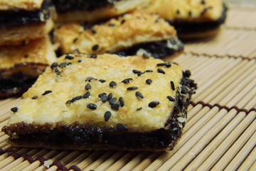 Mini black sesame pie on bamboo mat