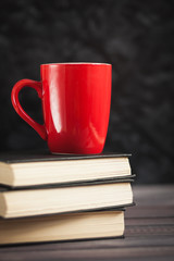 The red circle and black books on a dark background