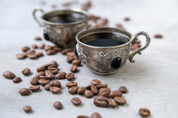 Coffee in silver vintage cups on wooden background