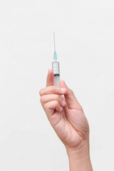 Doctor's hands holding syringe closeup