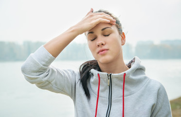 Portrait of a young sad woman  with headache, fatigue or cold. D