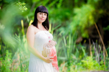 Pregnant woman near the lake.