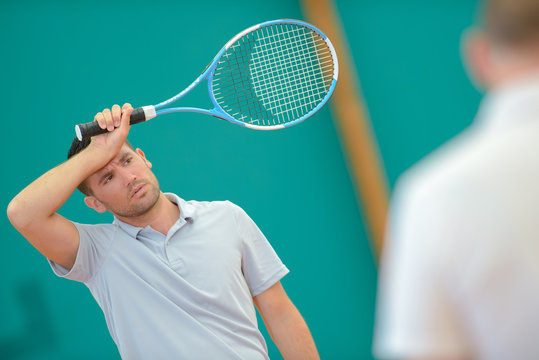 Exhausted man on tennis court