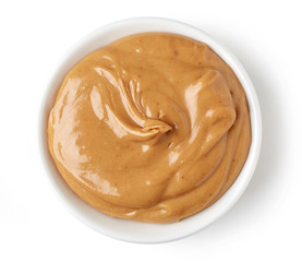 Peanut butter in round dish isolated on white background