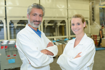 Fototapeta premium Portrait of two workers in white coats