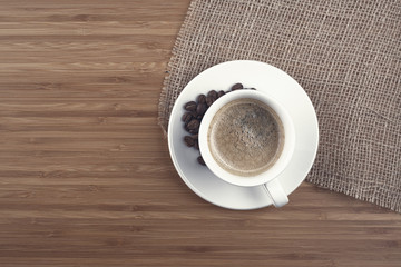Fresh coffee beans on wood and linen