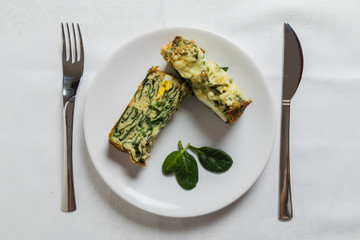 spinach souffle on white plate