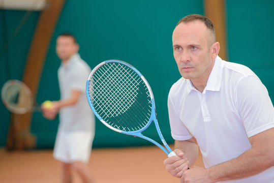 Two men playing tennis