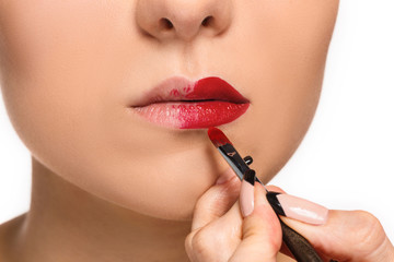 Beautiful female lips with make-up and brush