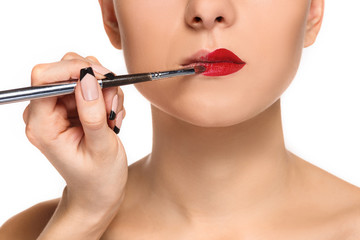 Beautiful female lips with make-up and brush