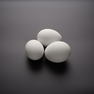 White eggs on black background