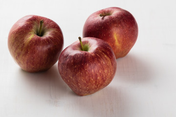 red apples on white table