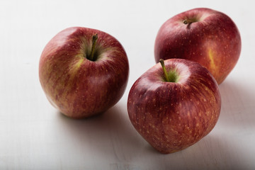 red apples on white table