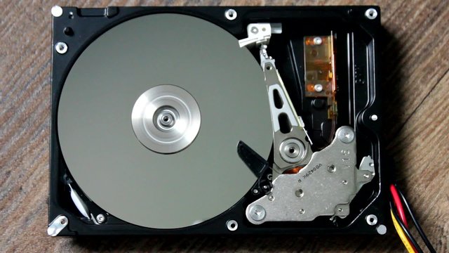 HDD - A Hard Disk Drive is open, broken and spin out