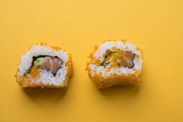 Various kinds of sushi food served on yellow blackground