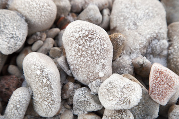 Winter background. Stones and snow in nature pattern. Close up i