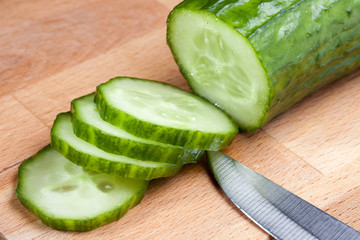 A slices of cucumber on the cutting board