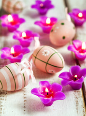 Candles and egg decorations on wooden background. Selective focu