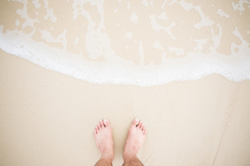 Feet stand with wave splash