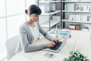 Confident businesswoman working at desk
