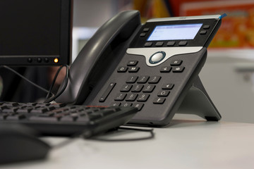 ip phone and computer on desk