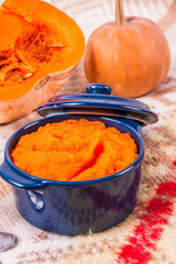 Pumpkin soup on wooden background