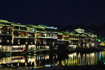 Fototapeta na wymiar View of illuminated riverside houses in Fenghuang