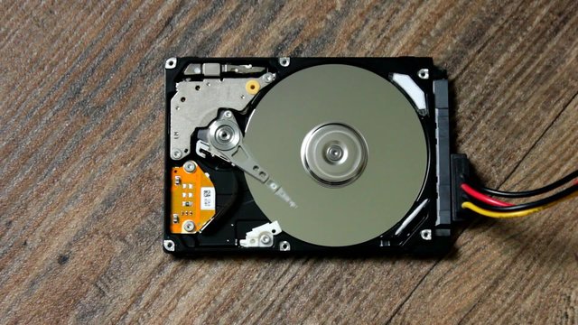 HDD - A Hard Disk Drive is open, broken and spin out
