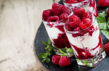 Vanilla ice cream with raspberries and mint dessert served in gl