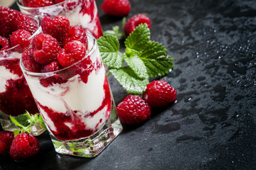 Vanilla ice cream with raspberries and mint dessert served in gl