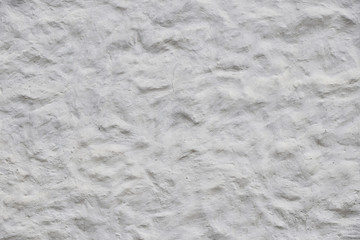 White wall of embossed decorative plaster