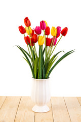 Red and Yellow and Pink tulips in pot on wood texture isolated o