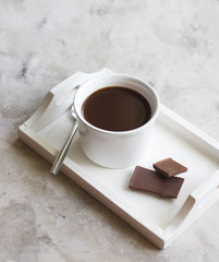 Cup of hot chocolate on wooden tray