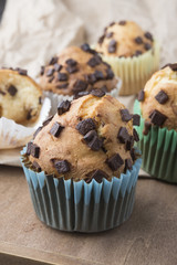 Muffins with chocolate on a wooden table