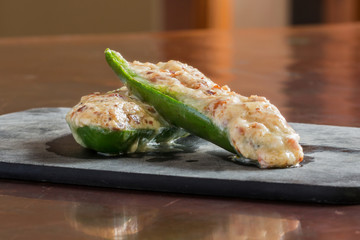 Cheesy stuffed jalapeno peppers snack prepared ready to eat on counter