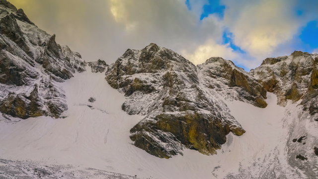 4K Timelapse. Clouds slowly cover the tops of the mountains in Sairam-Su
