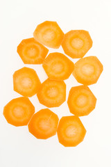 Carrots cut into circles on a white background