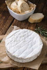 Creamy Camembert on wooden background