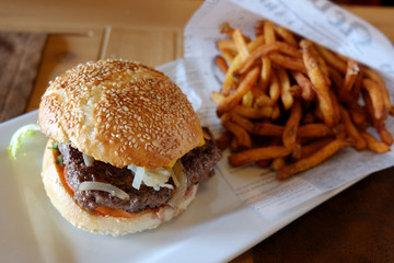 juicy burger with fried potatoes