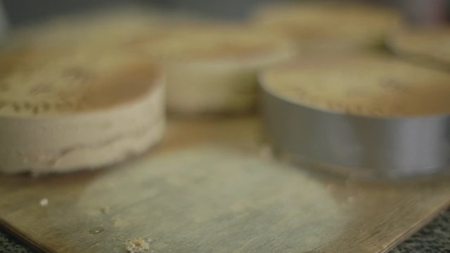 many large round cakes in tins
