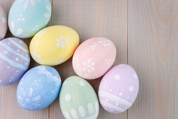 Easter painted eggs on wooden light background