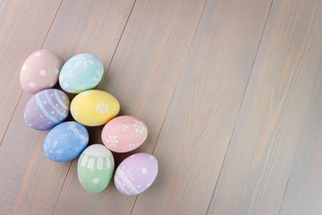 Easter painted eggs on wooden background. Empty space for text.