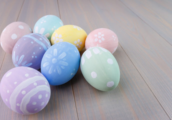 Easter painted eggs on wooden light background